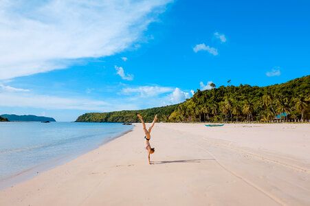 Woman girl beach handstand photo