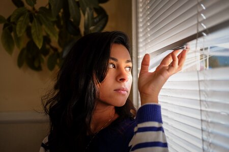 Woman girl window blind photo