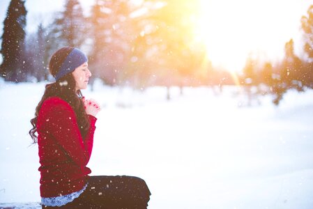 Woman praying snow photo
