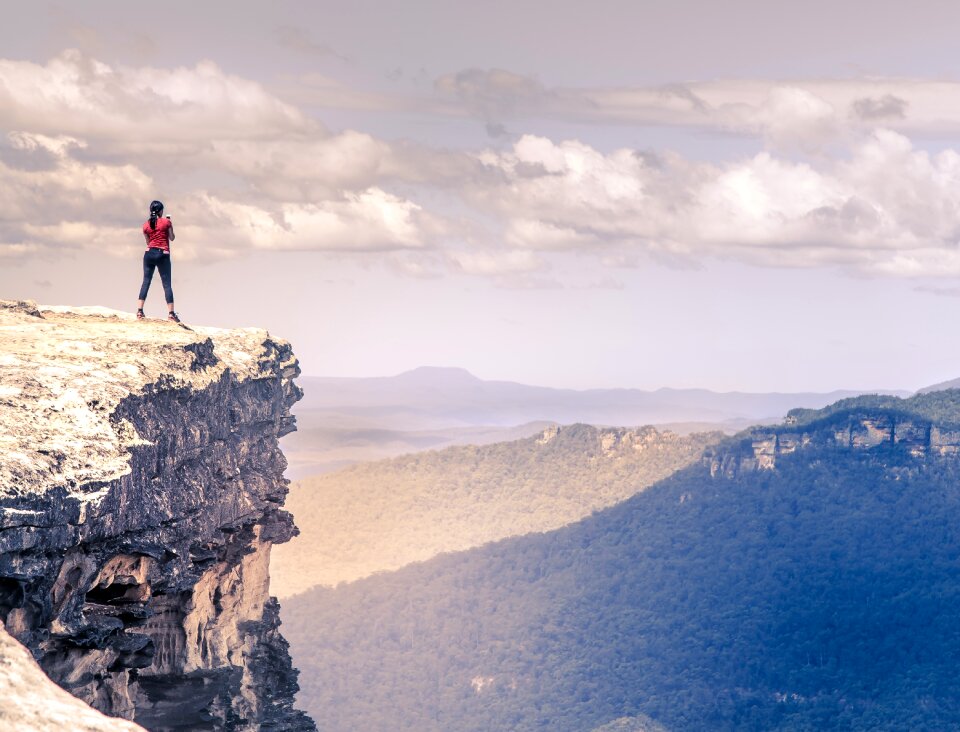 Woman rock cliff photo