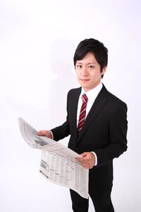 Business man reading newspaper
