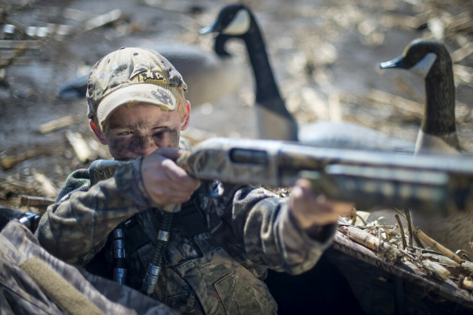 Child boy hunting gun