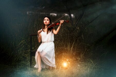 Girl playing violin lantern photo