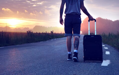 Traveler suitcase road sunrise photo