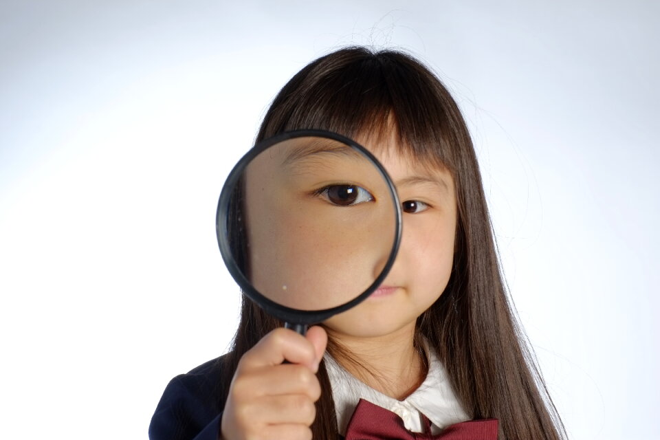Child girl magnifying glass