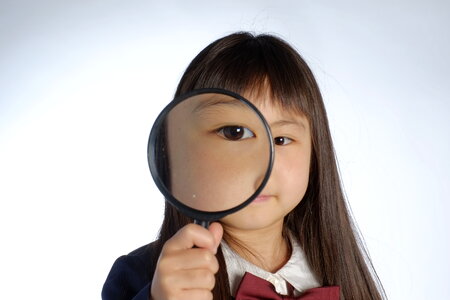 Child girl magnifying glass photo