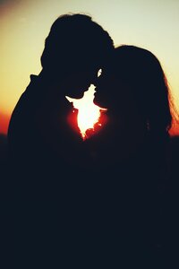 Couple kiss sunset silhouette photo