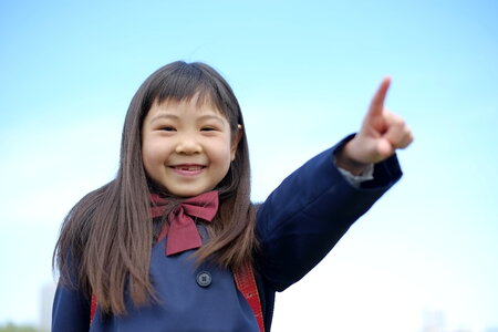 Schoolgirl pointing finger photo