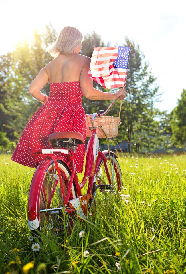 Woman bicycle american flag