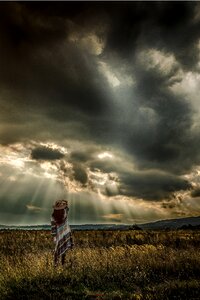 Woman dark clouds sunbeam