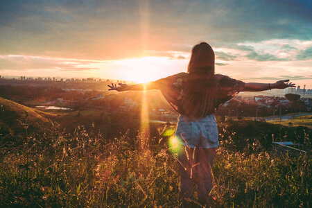 Woman sunrise grass