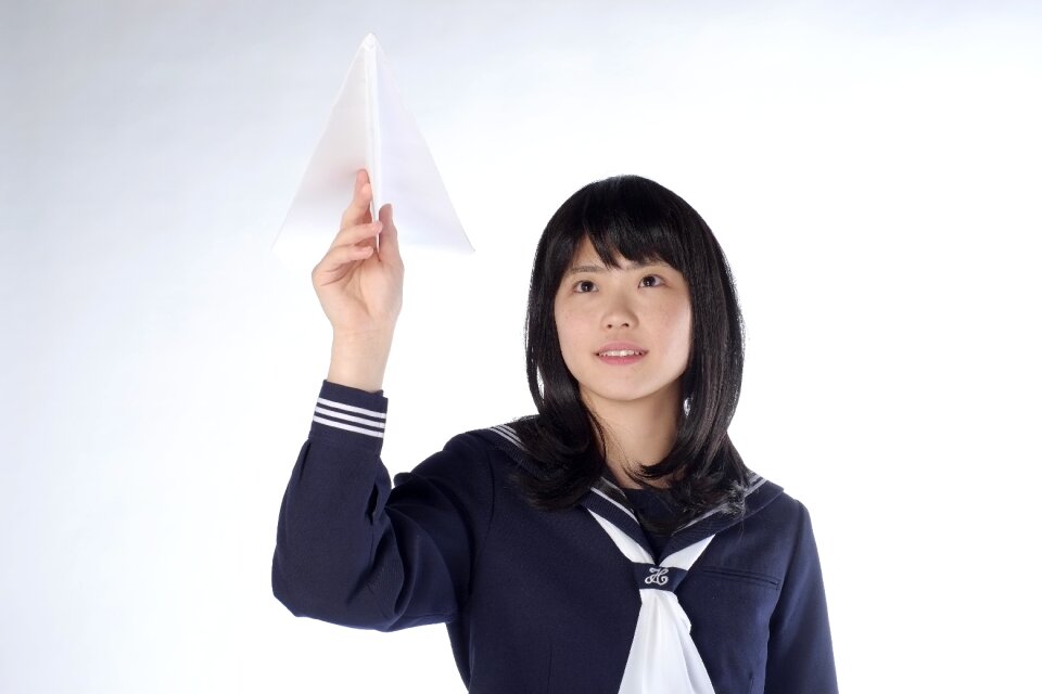 Female student paper airplane