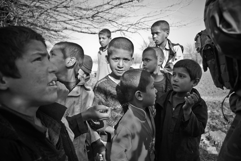 Boys begging soldiers