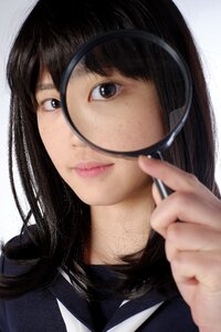 Female student magnifying glass photo