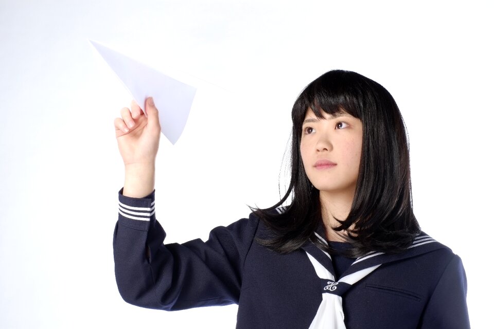 Female student paper airplane