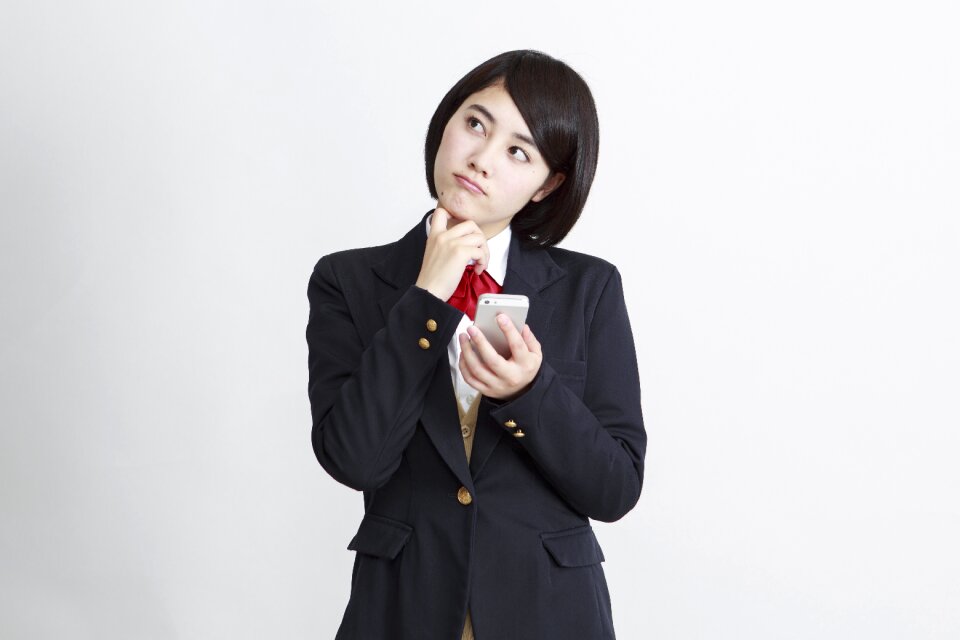Female student thinking smartphone