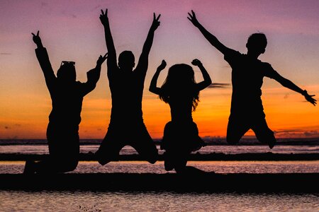 Group silhouette jump sunset photo