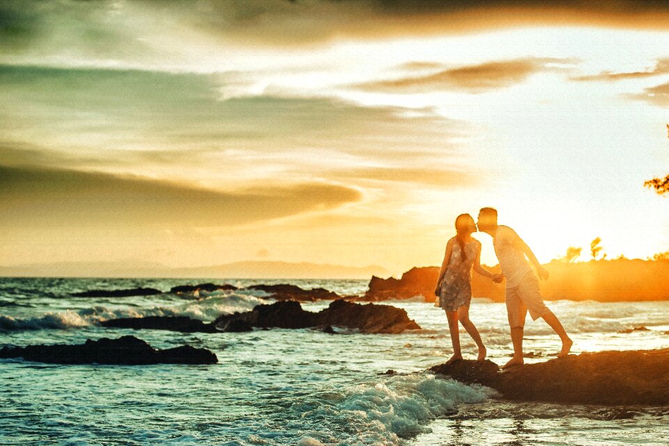 Kiss couple cost sunset photo