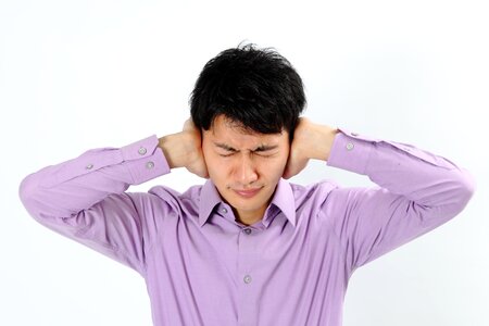 Man portrait cover ears