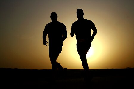 Men silhouette jogging sunset