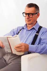 Senior man reading book photo