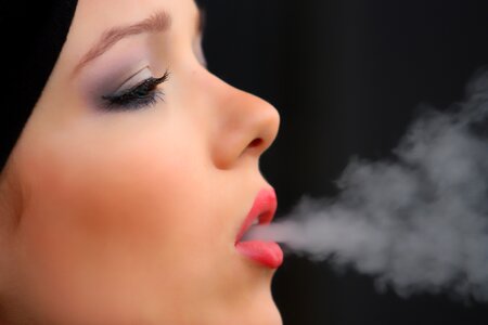 Woman smoking face photo