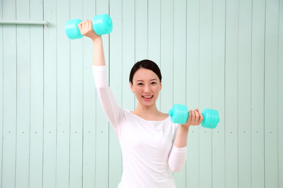 Woman girl training dumbbell