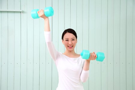 Woman girl training dumbbell