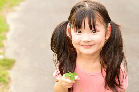 Child girl four leaf clover