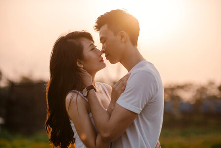 Couple sunset kiss photo