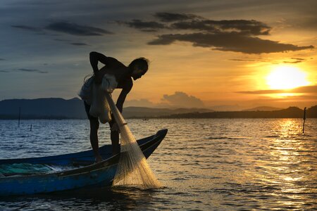 Fisherman fishing sea sunset
