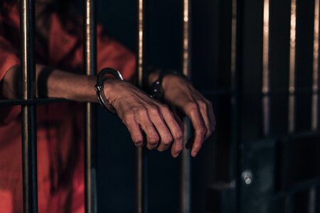 Hands handcuffs prison cell photo