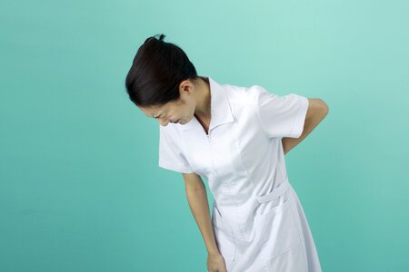 Nurse woman low back pain