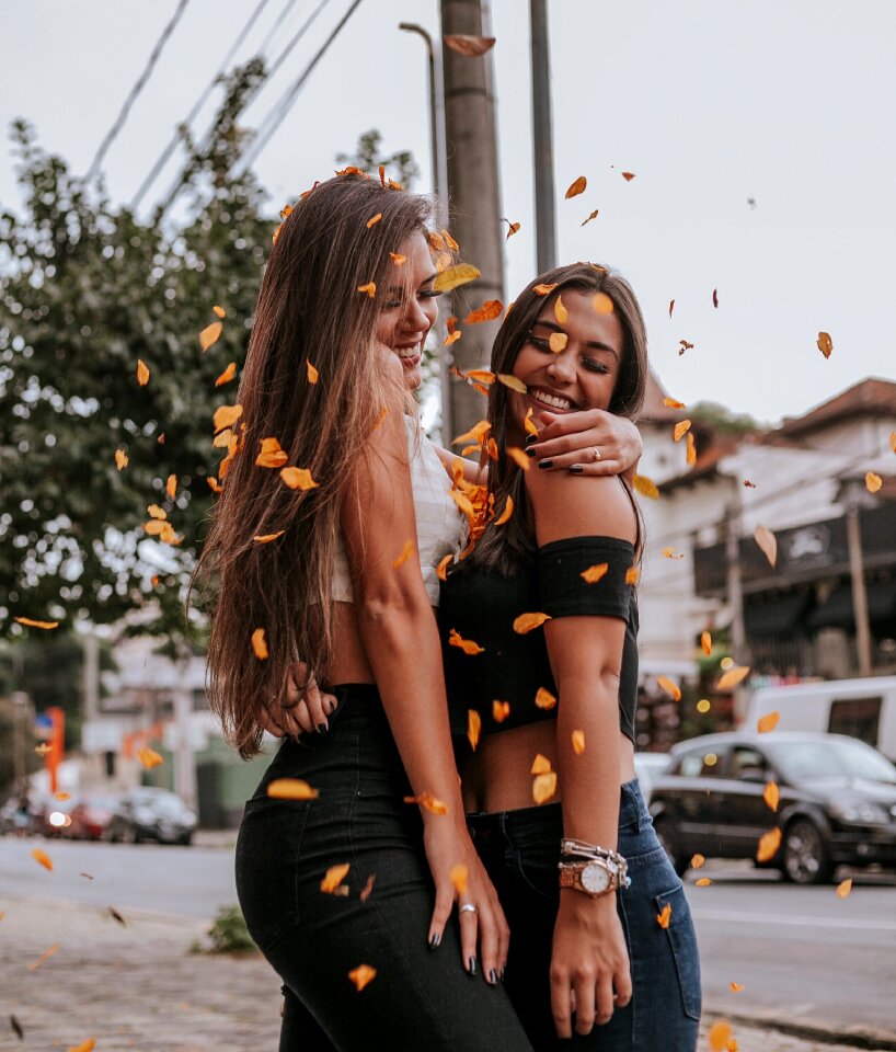 Two women fallen leaves