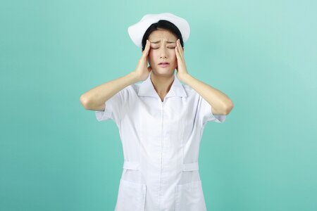 Woman nurse headache photo