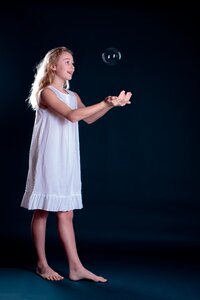 Child girl soap bubble photo