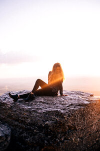 Woman girl sitting rock photo