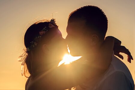 Couple kiss sunset photo