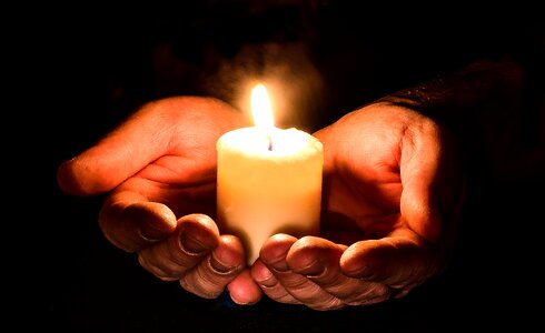 Hands candle flame