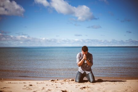 Man praying beach photo