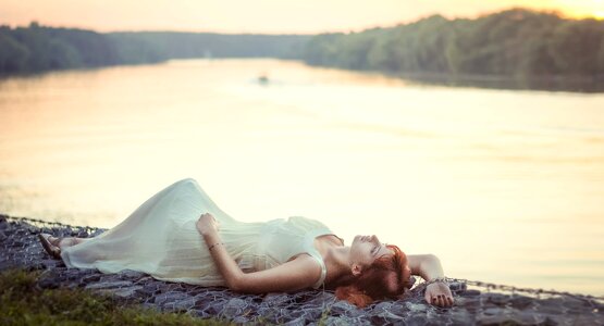 Woman girl laying river photo