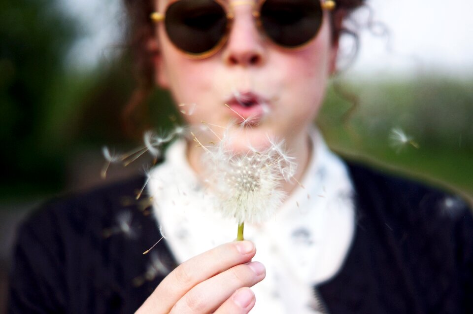 Woman blowing puffball photo