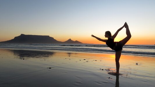 Yoga woman beach sunset photo