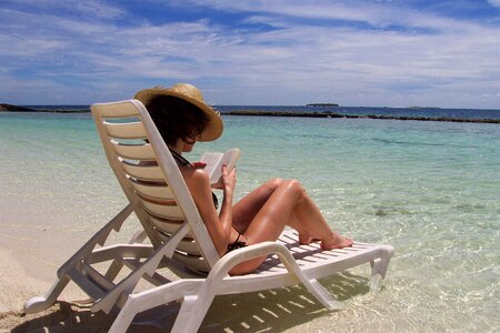 Woman reading book sea photo