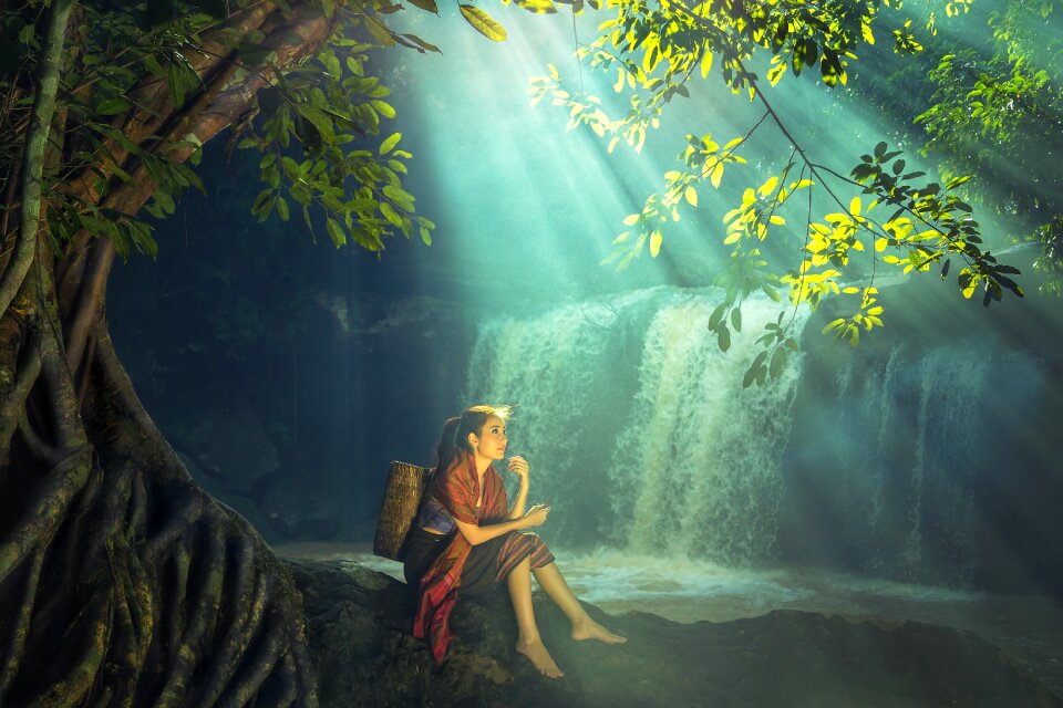 Woman waterfall sunbeam