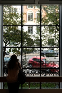Girl Watching Outside Through a Big Window