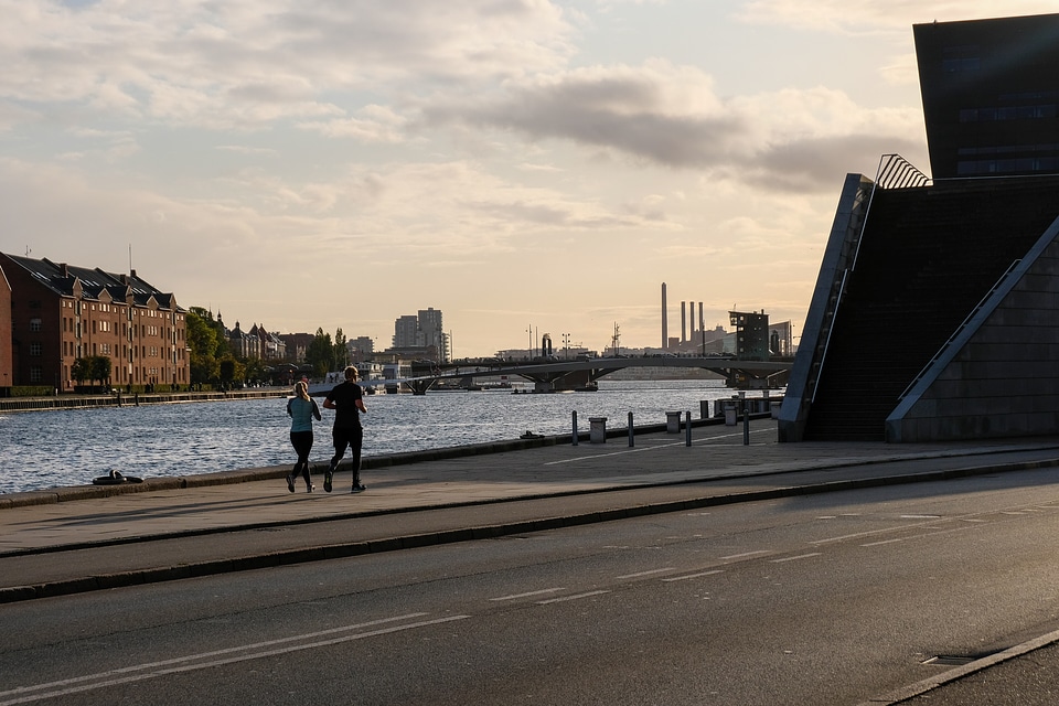 Couple Jogging Together Along the River Coas