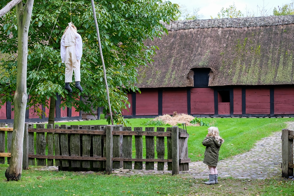 Little Girl Scared By Hangman Halloween Decoration