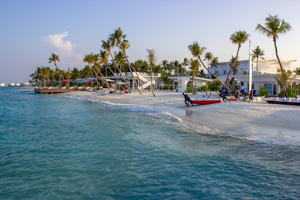 People Dragging a Pedalo Boat to the Sea