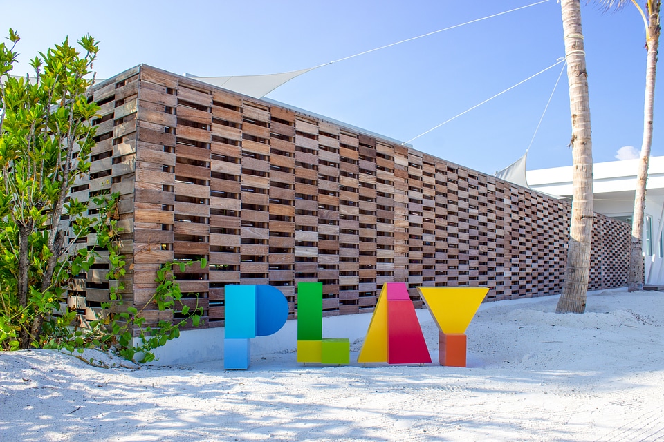 Colorful PLAY Sign On Sunny Beach With Fine Sand